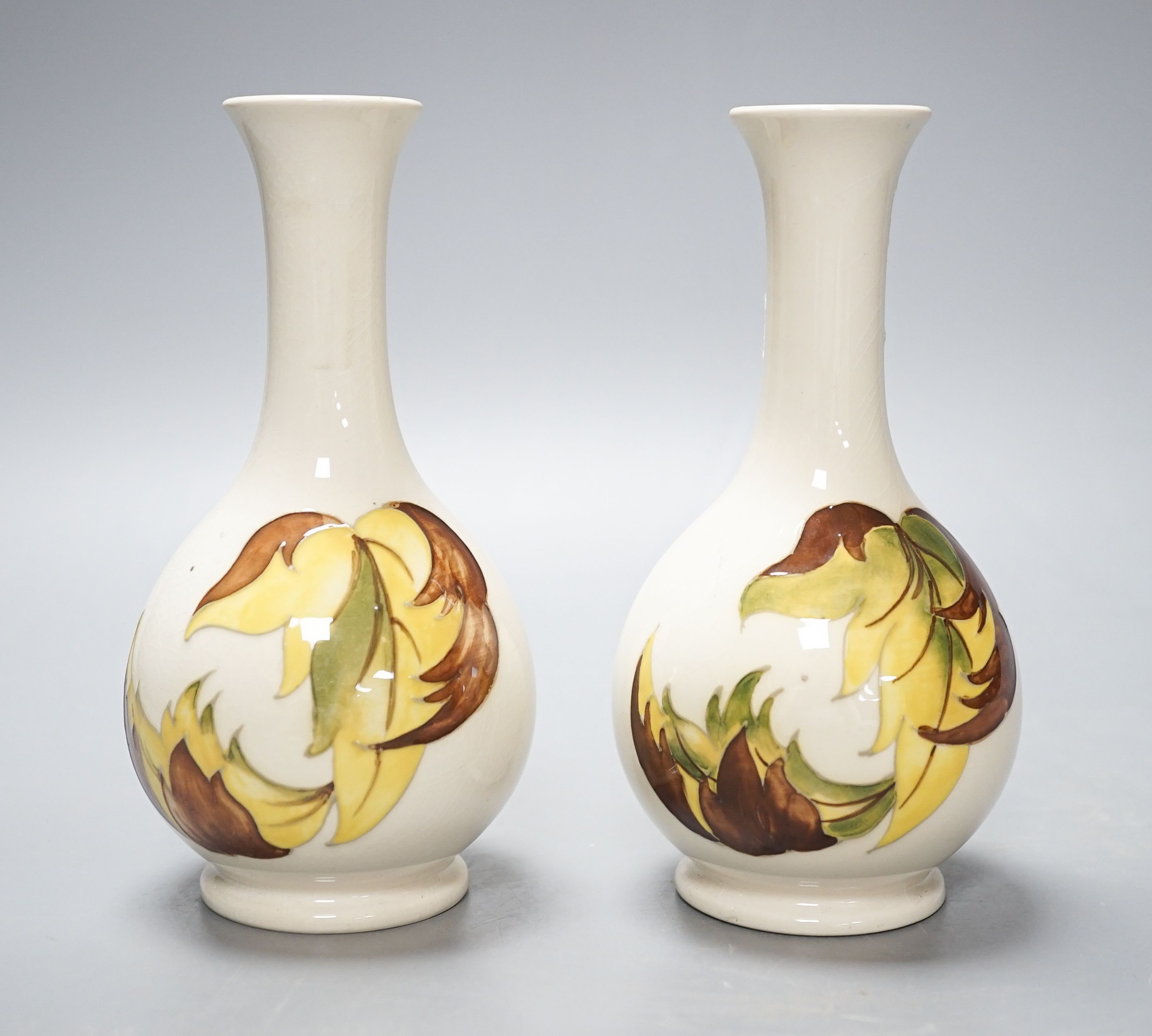 A pair of Moorcroft ‘leaves in the wind’ vases 15.5cm